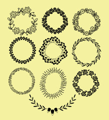 Hand drawn floral wreaths with leaves, flowers, and curlicues.