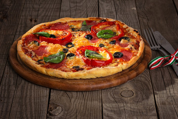 Delicious pizza served on wooden plate 