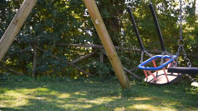 empty swing seats on playground without children 