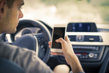 man in the car with the mobile phone