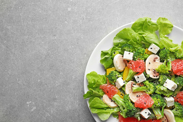 Plate with broccoli salad on grey background