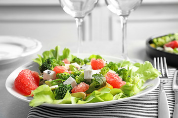 Plate with broccoli salad on table