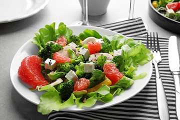 Plate with broccoli salad on table
