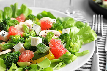 Plate with broccoli salad on table