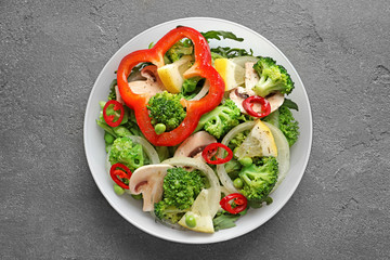 Plate with broccoli salad on grey background