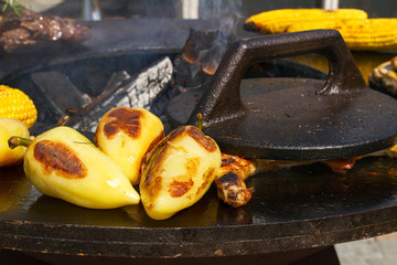 Barbecue outdoors. Cooking of grilled beef, chicken, corn and vegetables on open kitchen international food festival, event of street food
