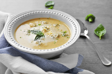 Broccoli cheddar soup in bowl on wooden kitchen table
