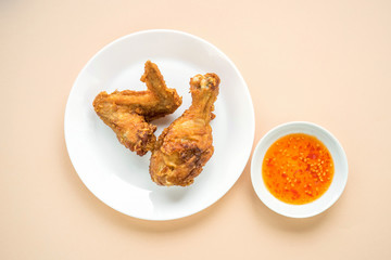 Fried chicken and sauce on color background.