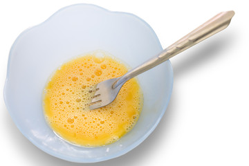 Egg in a cup ready for cooking, on a white background.
