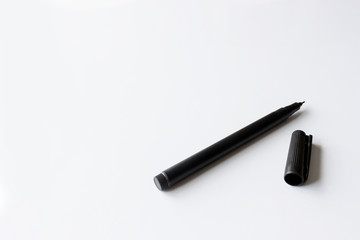 pen on white table with over light in the background