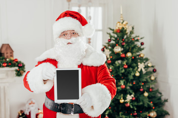 santa claus presenting tablet