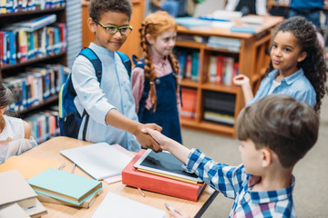 pupils shaking hands