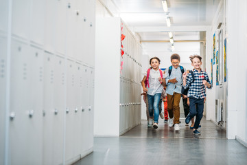 pupils running through school corridor