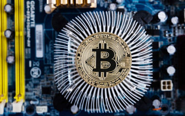 Gold bitcoin with microcircuits on a blue background. The concept of cryptocurrency..
