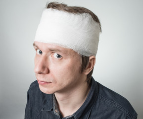 Man with bandage on his head