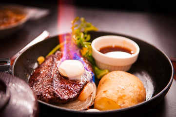 Beef steak with burning butter on top