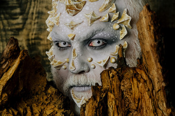 Man monster with white eyes and thorns on face