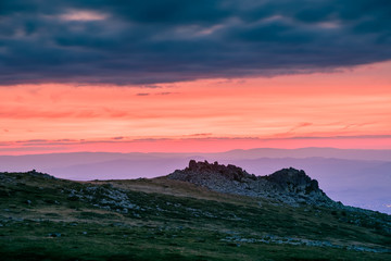 Amazing sunset over the mount of Vitosha, Bulgaria - colorful sky with dramatic dark clouds, over rocky outcrops