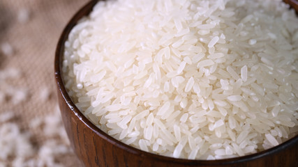 Close up of white rice in the wooden bowl. 