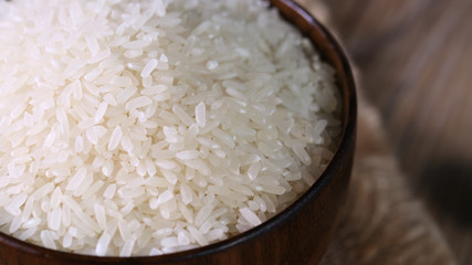 Close up of white rice in the wooden bowl. 