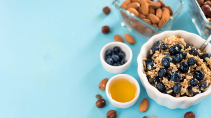 Perfect breakfast. Oatmeal with blueberries. Healthy eating for the whole family. wood background.