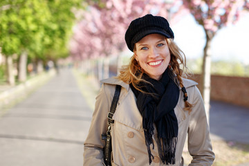 Happy young woman toothy smile at early spring
