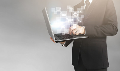  business man and suit holding laptop in hands