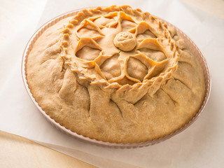 Tatar round pie on the table with napkin