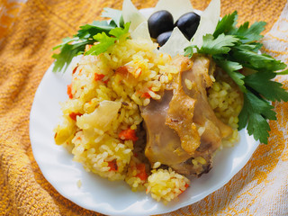 pilaf with meat on a white plate