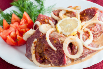 Raw pork beef meat on the white plate