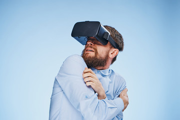 man in virtual reality glasses on a blue background