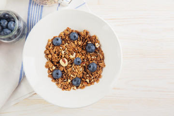 healthy breakfast homemade baked granola or muesli with fresh blueberries white background