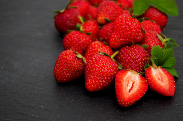 Strawberries on a black stone background
