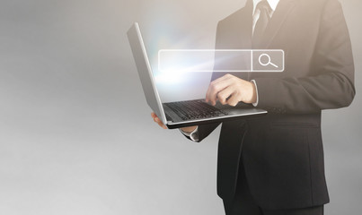  business man and suit holding laptop in hands