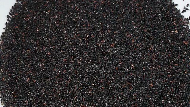 Black rice on the whtie table.