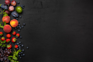 Fruits on the black rustic table. Top view.