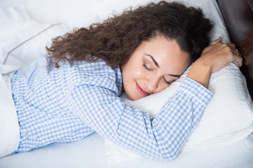 Cute adult girl smiling in her sleep