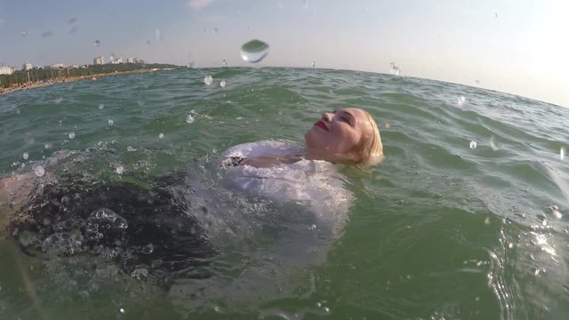 business woman swim in the sea