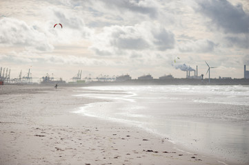Sand beach with industrial background with smoke, Netherlands