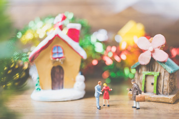 Miniature people in the village celebrate Christmas Day , Holiday concept.