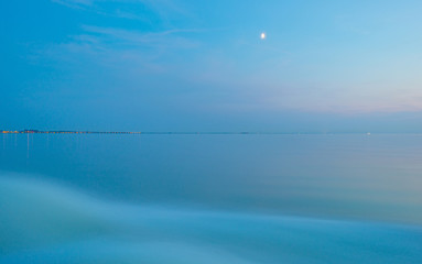 Sailing fast in the smooth water of a lake at sunset 