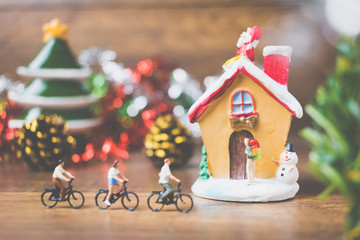 Miniature people in the village celebrate Christmas Day , Holiday concept.