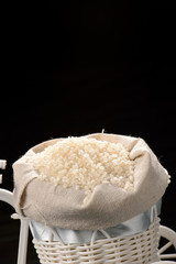 fulled rice in straw rice bag isolated on black background
