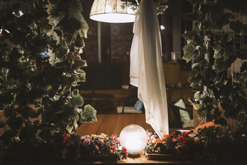Interior cafe. A table on the veranda in the evening with the light of a lamp.