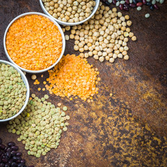 Various kinds of legumes on old rusty background. Top view, space for text.