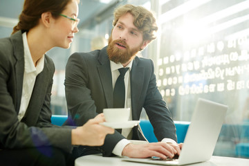 Two young brokers estimating financial situation on market