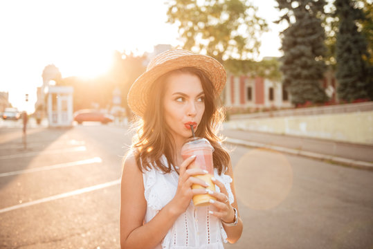 Beautiful Young Woman Outdoors Drinking Juice