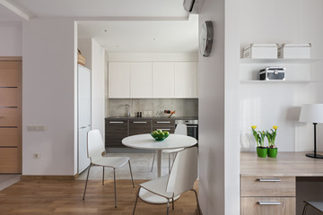 Interior of modern apartment in scandinavian style with kitchen and workplace.