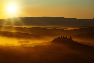 sun warm light on rolling hills in Tuscany