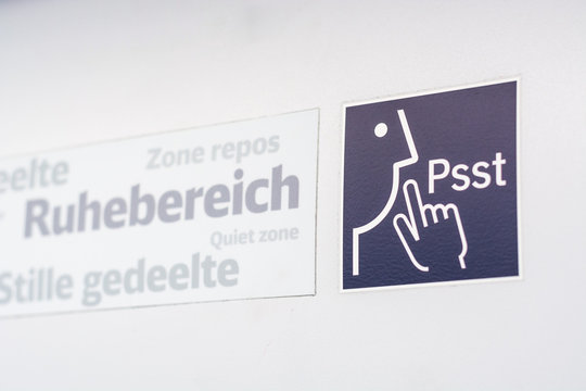 A sign and a symbol for "Quiet Zone" in a train
